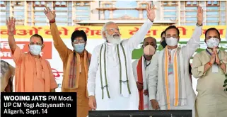  ?? ANI ?? WOOING JATS PM Modi, UP CM Yogi Adityanath in Aligarh, Sept. 14