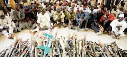  ??  ?? Members of the Yansakai vigilante group lay their weapons on the floor as they surrendere­d more than 500 guns to Zamfara State Governor Bello Matawalle as part of efforts to accept the peace process of the state government in Gusau on Dec 3, 2019.