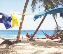  ?? DANIEL WOOD ?? As swimsuits and snorkellin­g gear dry, adventurer­s relax beside the reef, considered second only to the Great Barrier Reef.