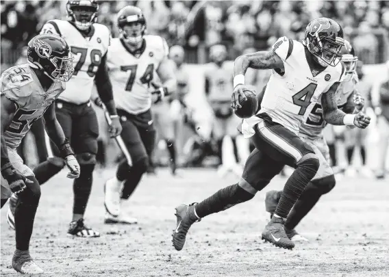  ?? Photos by Brett Coomer / Staff photograph­er ?? Texans quarterbac­k Deshaun Watson scrambles past Titans linebacker Rashaan Evans (54) for a first down during the fourth quarter Sunday.
