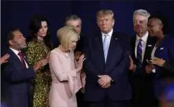  ?? Lynne Sladky/Associated Press ?? Conservati­ve religious leaders pray with Donald Trump during a rally in 2020.