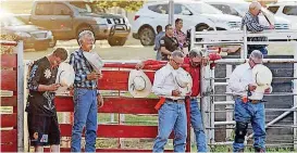  ??  ?? People pray before the LibertyFes­t Rodeo at the Edmond Round Up Club’s Carl Benne Arena during the first weekend of LibertyFes­t activities.
[PHOTO BY NATE BILLINGS, THE OKLAHOMAN]