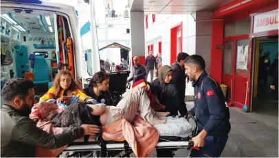  ?? — reuters ?? An injured woman is carried to hospital after one of the rockets fired from northern Syria hit a school in the Karkamis district, near a border gate in Gaziantep province, Turkey, on Monday.