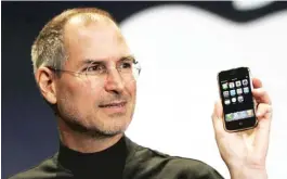  ?? | AP FILE PHOTO ?? Steve Jobs holds up the iPhone during a presentati­on in 2007.