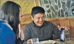  ?? ANUSHREE FADNAVIS/HT PHOTO ?? Tsultrim, a Tibetan living in India, and his partner Molly speak to his mother in Tibet via Wechat, while the two have lunch in Mcleodganj.