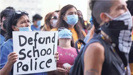  ?? MARIO TAMA/GETTY IMAGES ?? Protesters call for defunding the Los Angeles school district police on June 22.