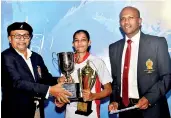  ??  ?? Best women’s fencer Nishani Srikanthi Fernando receiving her trophy from Chief Guest Dian Gomes, former President NFASL and incumbent President of ABA. Flanked by Ajith Siyambalap­itiya, President NFASL.