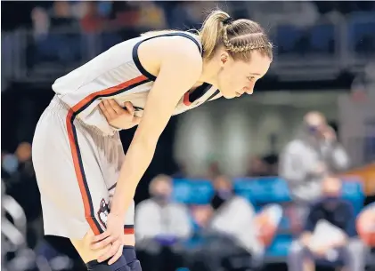  ?? ELSA/GETTY ?? UConn guard Paige Bueckers reacts after an injury against Arizona during the third quarter of the national semifinal of the NCAA Tournament on Friday in San Antonio. UConn fell 69-59 to the Wildcats, ending its season at 28-2.