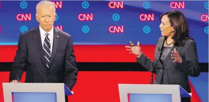  ??  ?? Former U.S. vice-president Joe Biden listens as California Sen. Kamala Harris speaks Wednesday during the second of two Democratic presidenti­al primary debates this week in Detroit.