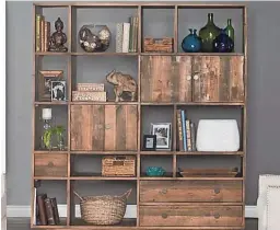  ?? PERIGOLD/KOSAS HOME ?? A large bookshelf can be used to divide a room into two smaller spaces.