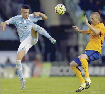  ?? — AFP ?? Celta Vigo’s Iago Aspas (left) vies with Barcelona’s Jeremy Mathieu during the Spanish league match in Vigo.