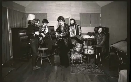  ??  ?? “The story of The Band was unique and so beautiful, and it went up in flames,” Robbie Robertson (third from left with the guitar) says in the new documentar­y,
Once Were Brothers. The other members of the group, shown in this circa 1969 photo are (from left), Levon Helm on mandolin, Rick Danko on bass, Garth Hudson on accordion and Richard Manuel on drums.