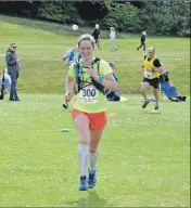  ??  ?? 01_B21goatfel­l08 First local runner Kirstie Smith makes one final effect as she crosses the finish line.