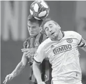  ?? CURTIS COMPTON/TNS ?? Atlanta United's Mikey Ambrose, left, and the Philadelph­ia Union's Alejandro Bedoya battle for a header in October.