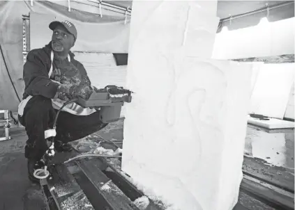  ?? ARIEL COBBERT/ THE COMMERCIAL APPEAL ?? Chef Steven Leake uses a 14 inch chainsaw to sculpt a block of ice into a swan at Southwest Tennessee Community College on Tuesday, February 18, 2020.