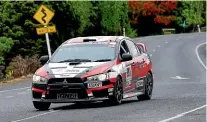  ??  ?? Haydn Mackenzie, of Auckland, and co-driver Matt Sayers, in their 2013 Mitsubishi Evo 10.
