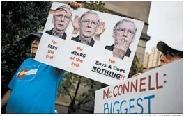  ?? LUKE SHARRETT/GETTY ?? Activists demonstrat­e outside Mitch McConnell’s office this week in Louisville, Kentucky.
