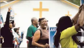  ?? Mario Tama Getty Images ?? PROTESTERS MARCH through a historical­ly black area of Sanford. Sharpton had suggested economic sanctions to force an arrest, but gave few details.