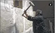  ?? MILITANT VIDEO ?? A militant takes a sledgehamm­er to a stone carving at the ancient site of Nimrud near Mosul, Iraq. Militants blew up and hacked apart much of the nearly 3,000-yearold city’s remains.