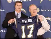  ?? DENIS POROY / AP ?? In this April 25, 2004, file photo, Chargers quarterbac­k Philip Rivers, left, holds up his jersey with coach Marty Schottenhe­imer at a news conference in San Diego. Rivers announced his retirement Wednesday.