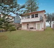  ??  ?? This rundown beachfront cottage at 58 Marine Pde, Miami, is expected to garner plenty of attention at auction.