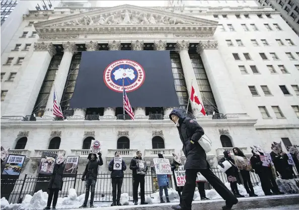  ?? MICHAEL NAGLE/BLOOMBERG ?? People for the Ethical Treatment of Animals activists protest against Canada Goose’s use of coyote fur in its jackets in front of the New York Stock Exchange on Thursday. Canada Goose will face challenges to live up to the high expectatio­ns set by its...