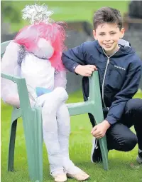  ??  ?? Ben Walmsley, 13, checks out one of the angels on display