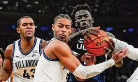  ?? Frank Franklin II/Associated Press ?? Villanova's Justin Moore, center, fights for control of the ball with UConn's Adama Sanogo during last season's Big East tournament semifinals in New York.