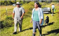  ??  ?? Left: Sunny the dog follows Flying Turtle Farm and Lupi's owner Dorris Shober, middle, and farming manager Tom Maynard, left, during a tour of the farm.