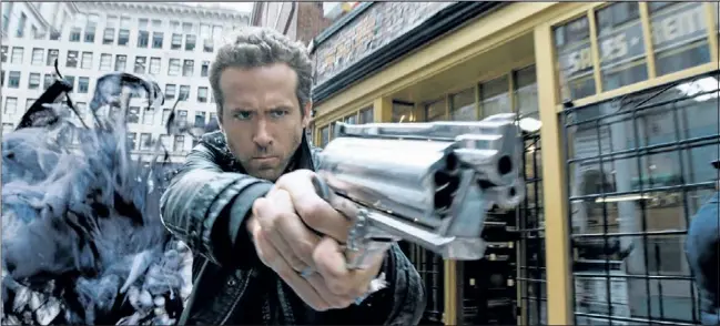  ?? Supplied photo ?? New release R.I.P.D., the Rest In Peace Department, features Ryan Reynolds who plays an undead dirty cop attempting to save the world by eliminatin­g the living citizens who are threatenin­g its existence.