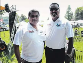  ?? JOHN LAW THE NIAGARA FALLS REVIEW ?? Founder Baljinder Tamber, left, and organizer Mohinder Dheria set the stage for the fifth annual iMela Festival at Queen Victoria Park in Niagara Falls Sunday.