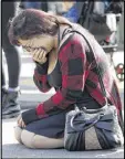  ?? MARCIO JOSE SANCHEZ / AP ?? A woman, wishing to not be identified, cries at the scene of a warehouse fire in Oakland, Calif. Officials said they are continuing to search the charred rubble.