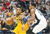  ?? RUSS ISABELLA-USA TODAY SPORTS ?? UTAH JAZZ guard Donovan Mitchell dribbles the ball as San Antonio Spurs guard DeMar DeRozan defends during the first half at Vivint Smart Home Arena.