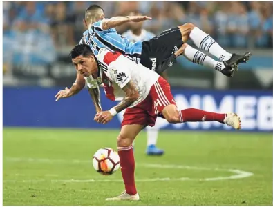  ?? — AP ?? Getting rough: River Plate’s Enzo Perez (bottom) vying for the ball with Gremio’s Cicero during the second leg of the Libertador­es Cup semi-finals in Porto Alegre on Tuesday.