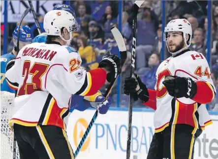  ?? AP PHOTO/JEFF ROBERSON ?? Calgary’s Matt Bartkowski is congratula­ted by Sean Monahan after a third-period goal on Saturday in St. Louis.