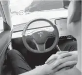  ?? DREAMSTIME 2019 ?? A man uses Autopilot technology in a Tesla. Federal officials are looking into a string of recent accidents in which the technology was or may have been used.