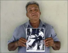  ?? JUD ESTY-KENDALL — STORYCORPS VIA AP ?? This photo provided by STORYCORPS shows Juan Romero holding a Los Angeles Times photograph that shows Romero with Sen. Robert F. Kennedy at the Ambassador hotel in Los Angeles moments after Kennedy was shot.