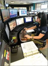  ?? NWA Democrat-Gazette/FLIP PUTTHOFF ?? Beverly Luper works Tuesday in the Rogers Police Department dispatch center. Rogers police hope voters will approve a bond issue that includes money to build a new dispatch center.