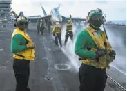  ?? Spc. 3rd Class Matt Brown / U.S. Navy ?? Navy sailors conduct flight operations on the flight deck of the aircraft carrier Carl Vinson last week.