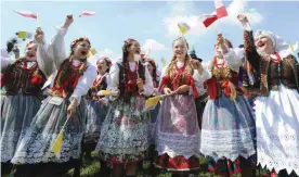  ??  ?? KRAKOW: A group of folk dancers rehearse prior to the arrival of Pope Francis at the military airport. — AP