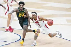  ?? AP Photo/Mark Humphrey ?? ■ Arkansas’ J.D. Notae (1) drives against Missouri's Kobe Brown (24) in the first half of Southeaste­rn Conference Tournament game March 12 in Nashville, Tenn.