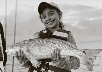  ?? Coastal Conversati­on Associatio­n Texas ?? Marilyn Monroe, 8, of Cypress caught the second tagged redfish of the CCA Texas STAR Tournament.