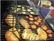  ??  ?? Chicken breasts and vegetables are grilled at a community day in Upper Frederick. Lean chicken selections are a great heart healthy choice.