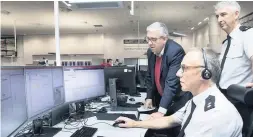  ?? Picture: MANDY JONES ?? Police and Crime Commission­er Arfon Jones, left, visits North Wales Police’s control centre, St Asaph, with Merfyn Jones and Superinten­dent Neil Thomas,standing