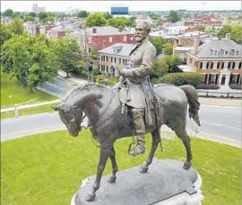  ?? Steve Helber Associated Press ?? PLANS to rally at this Robert E. Lee monument in Richmond, Va., against the removal of Confederat­e statues were canceled after the Charlottes­ville violence.