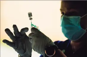  ?? Matt Rourke / Associated Press ?? A syringe is prepared with the Pfizer COVID-19 vaccine.