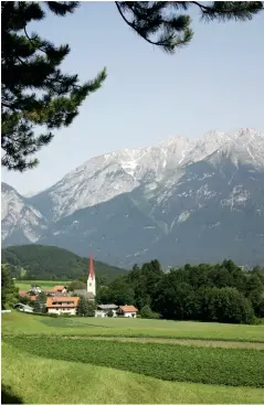  ??  ?? Opposite page, from bottom: There are many places with great views over the city; Wooden puppets for sale in a souvenir shop. From left: The village of Igls;
The Nordketten cable car high above Innsbruck.