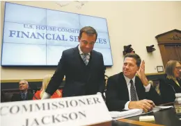  ?? AP FILE PHOTO ?? Securities and Exchange Commission Chairman Jay Clayton, center, waves to a commission­er in September as he takes his seat between SEC Commission­ers Robert Jackson Jr., left, and Hester Peirce, at the start of a House Financial Services Committee hearing on Capitol Hill in Washington, D.C.