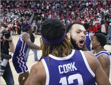  ?? CHASE SEABOLT — THE ASSOCIATED PRESS ?? TCU’s Xavier Cork (12) and JaKobe Coles (21) celebrate a win over Texas Tech after an NCAA college basketball game on Saturday.
