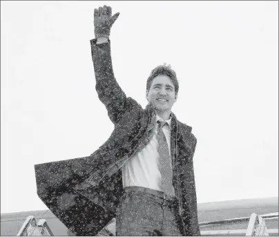  ?? CP PHOTO ?? Prime Minister Justin Trudeau waves as he boards the government airplane on his way to Chicago, in Ottawa Wednesday.